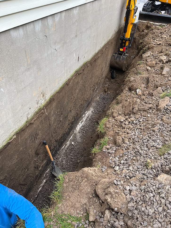 Exterior excavation exposing basement foundation